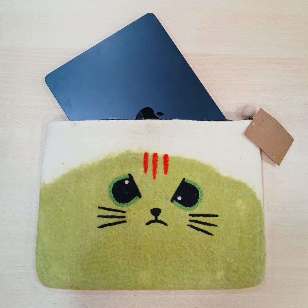 Cream and muted-green felt laptop pouch with grumpy cat face
