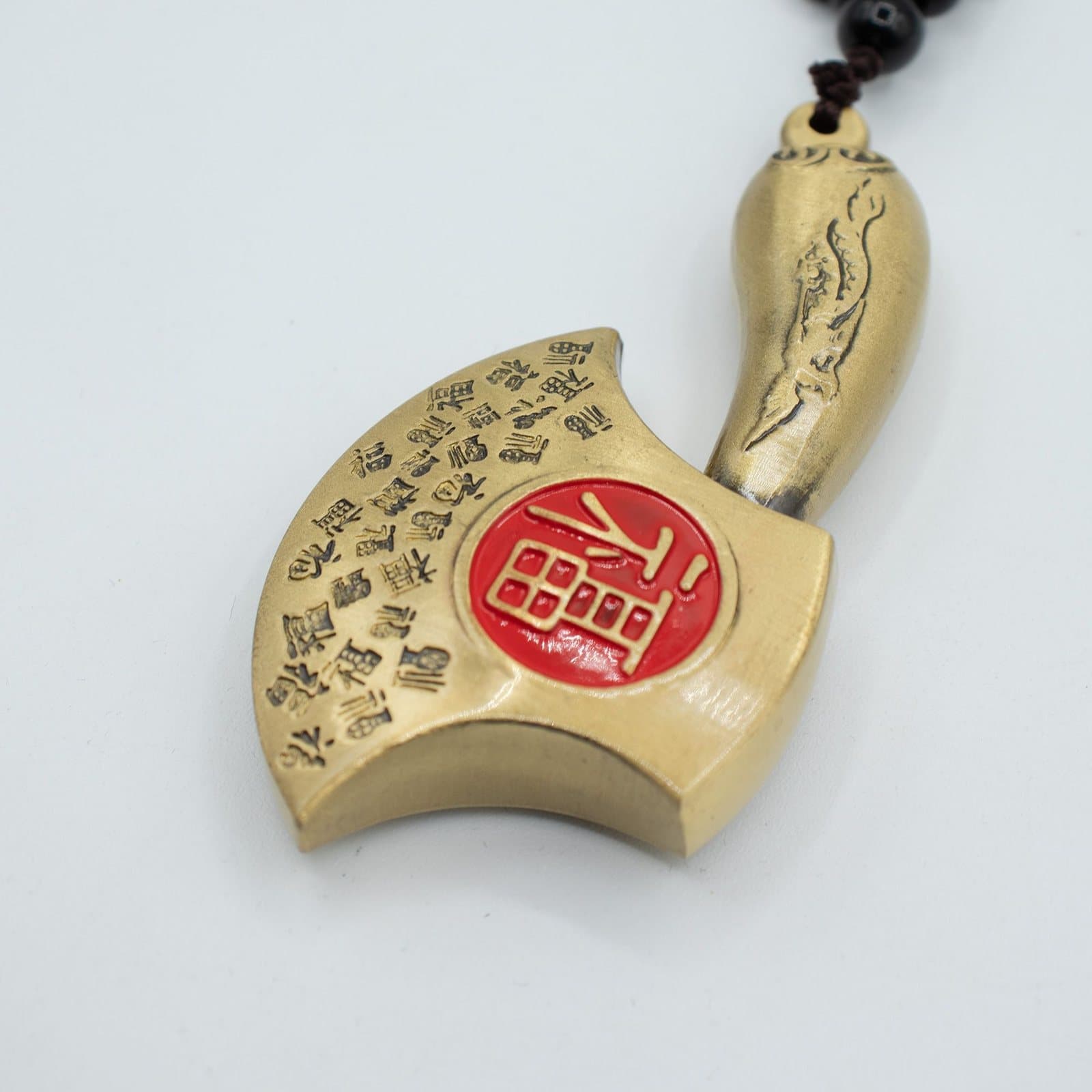 Brass feng shui hanging axe with coin motif and Chinese characters