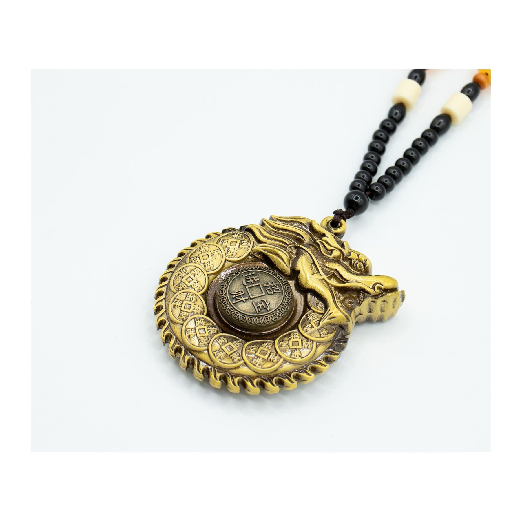 Brass Feng Shui hanging with a dragon circling a wealth coin on a beaded cord