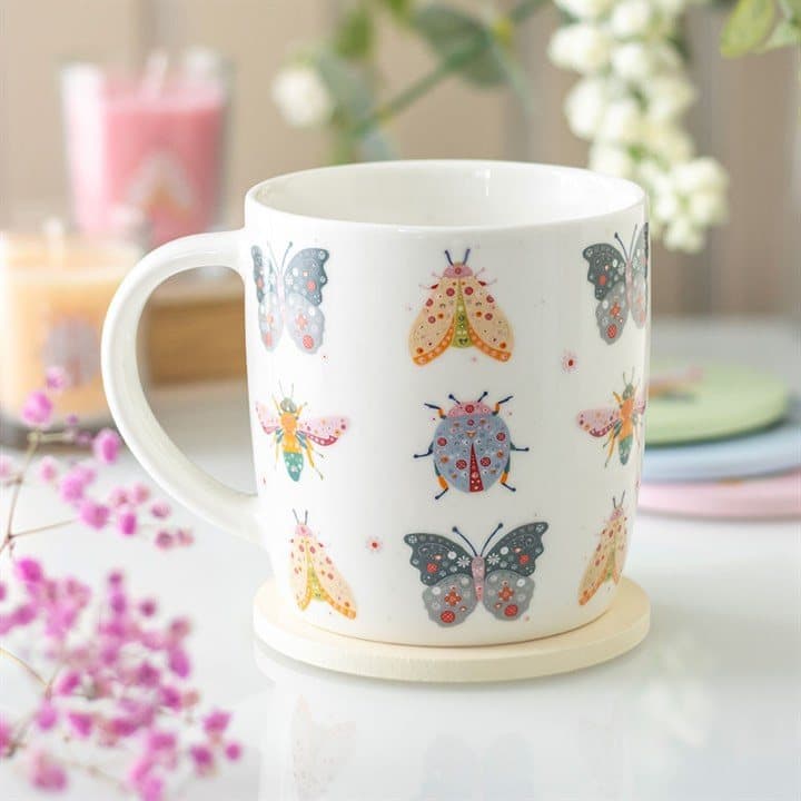 Ceramic mug with a playful floral bug design