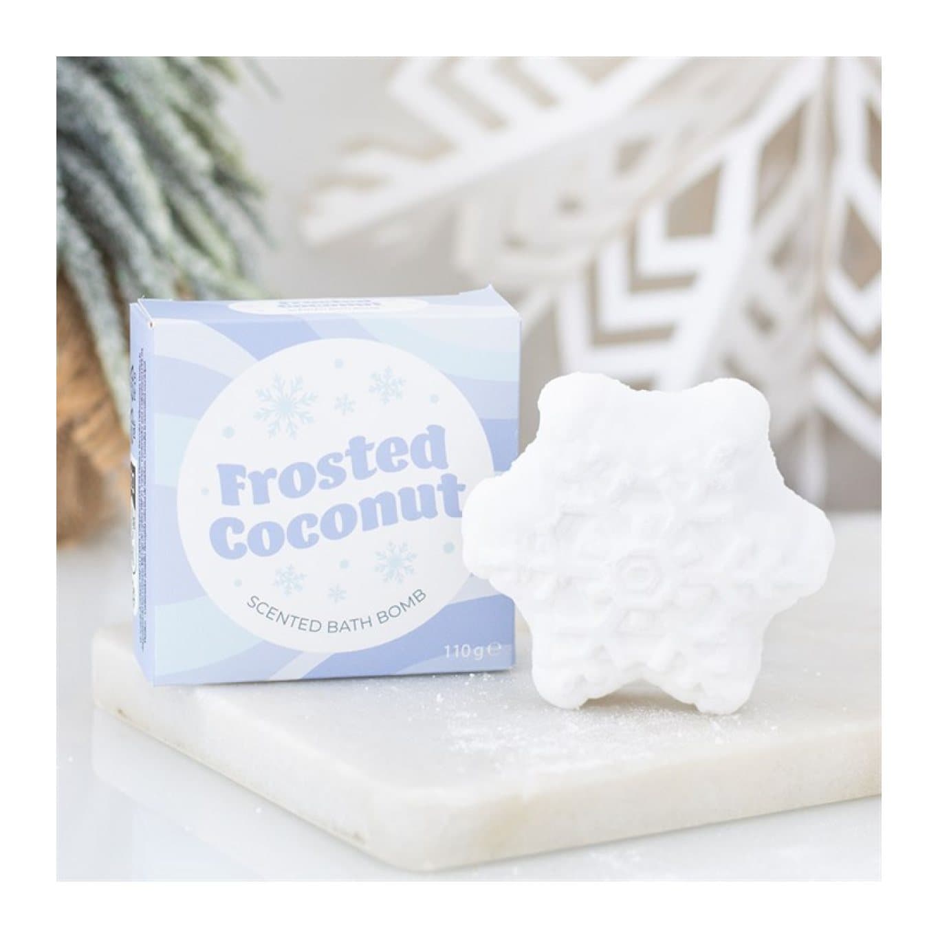 Snowflake-shaped coconut bath bomb in a colour cardboard box with cellophane