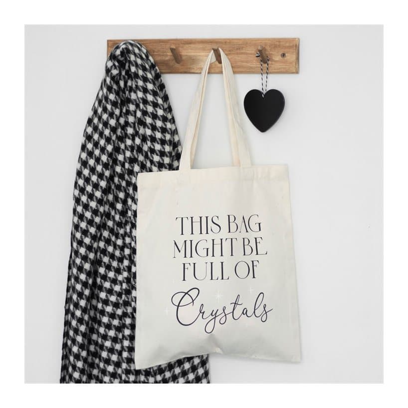 White tote bag with the text 'This bag might be full of crystals'