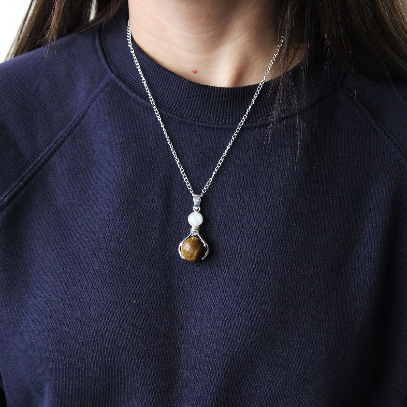 Tiger eye hands pendant on a silver-plated chain