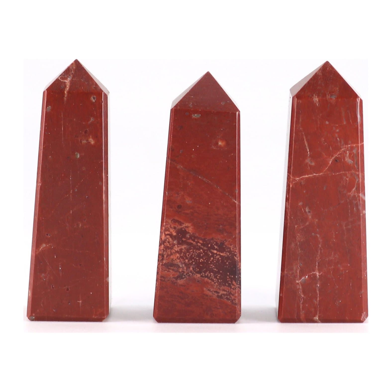 Polished red jasper gemstone obelisk point with natural patterns