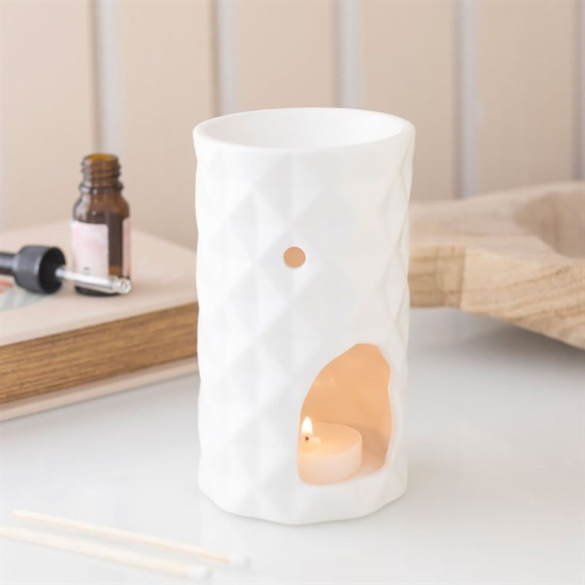 Ceramic geometric faceted oil burner with a modern design
