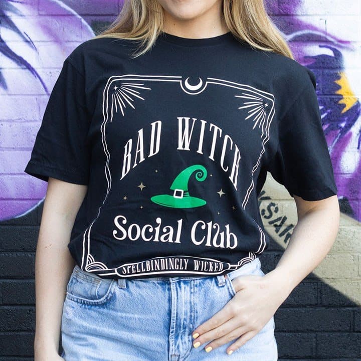 Green Bad Witch Social Club t-shirt with bold text and a pointed witch hat