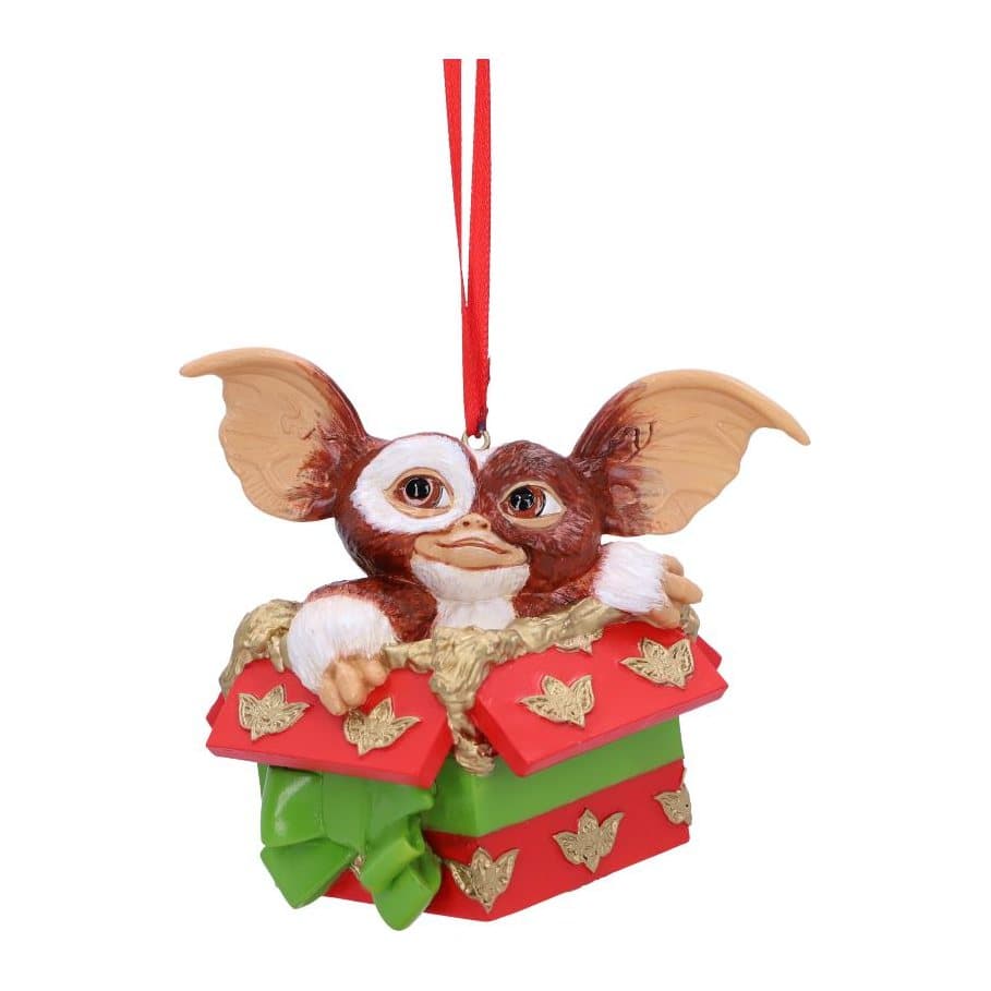 Gizmo peeking up from a present decorated in Gremlins wrapping paper