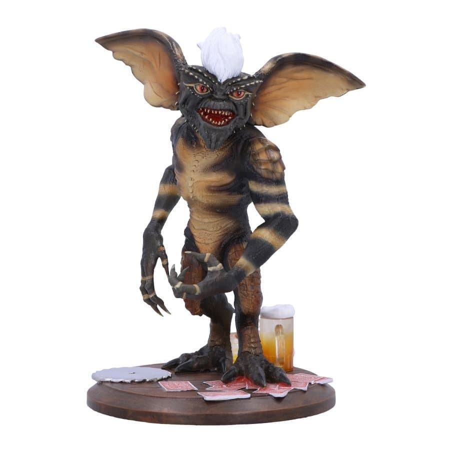 Gremlins Stripe collectible figurine on a bar table with beer and poker cards