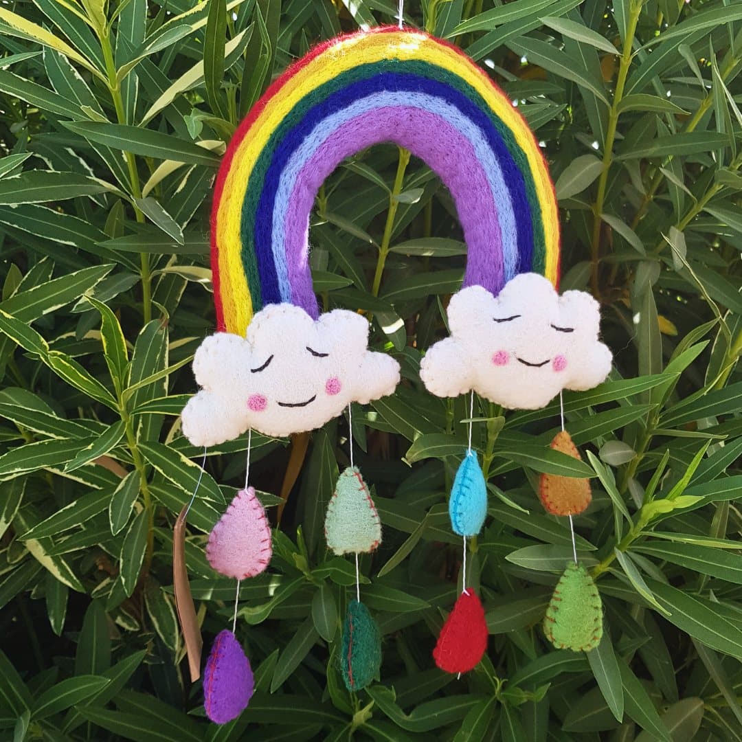Handmade felt mobile with a rainbow, two smiling clouds and colourful raindrops