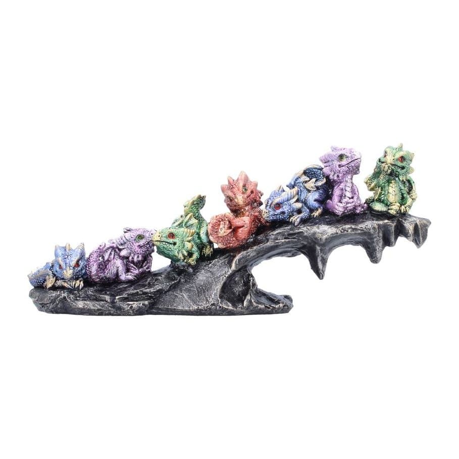 Group of colourful hand-painted baby dragons resting on a rocky base