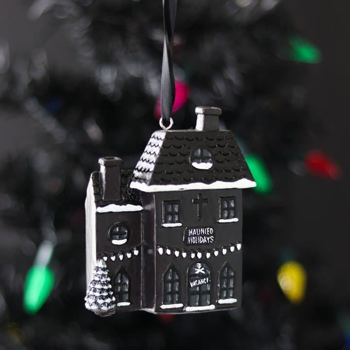 Black resin haunted house ornament with ghosts