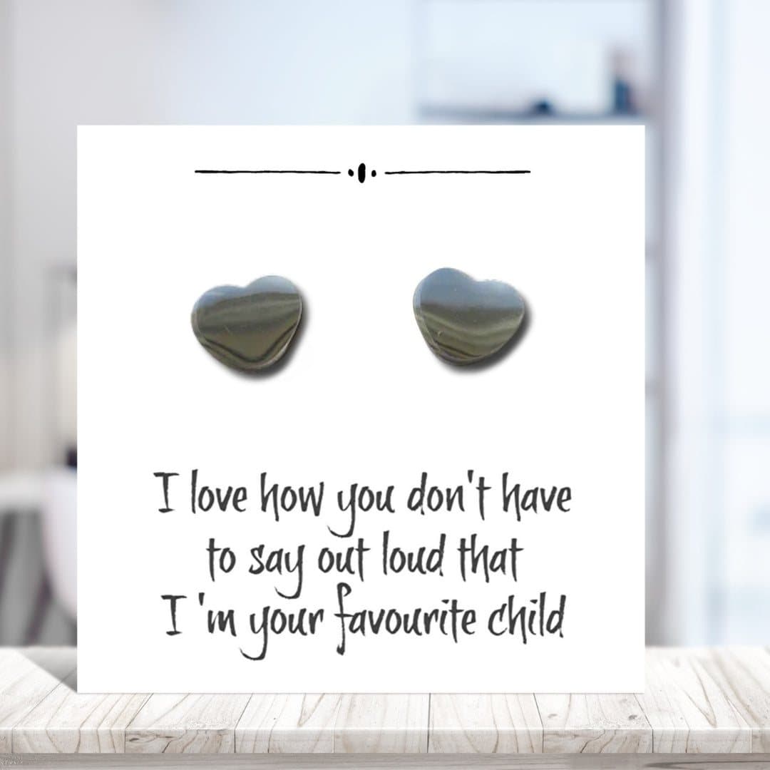 Silver heart earrings on a funny message card for mum