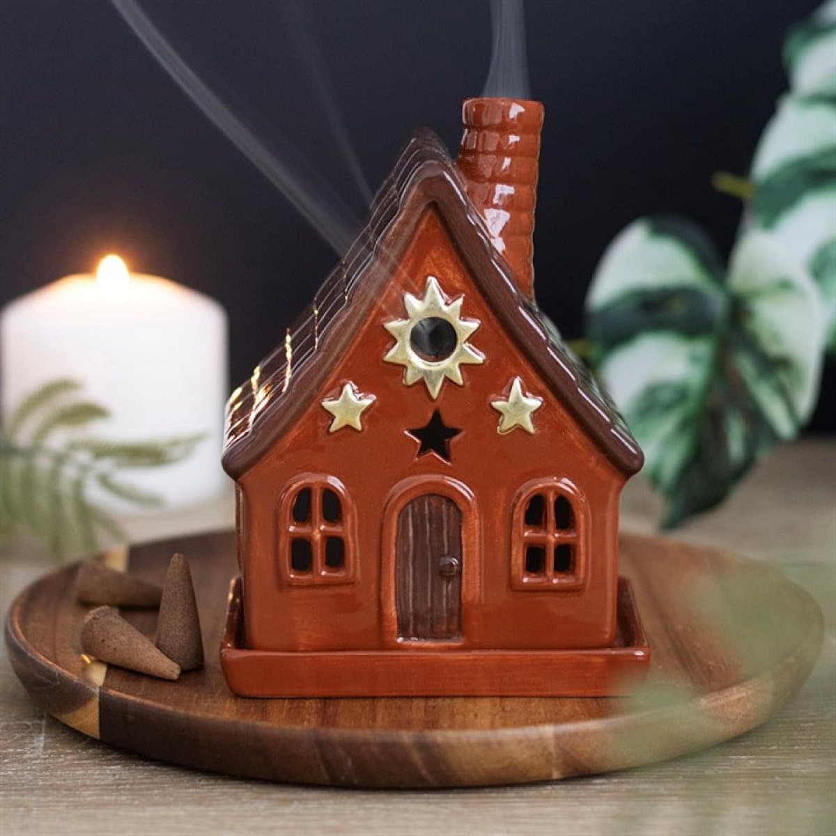 Ceramic cottage incense cone holder with sun motifs and a chimney