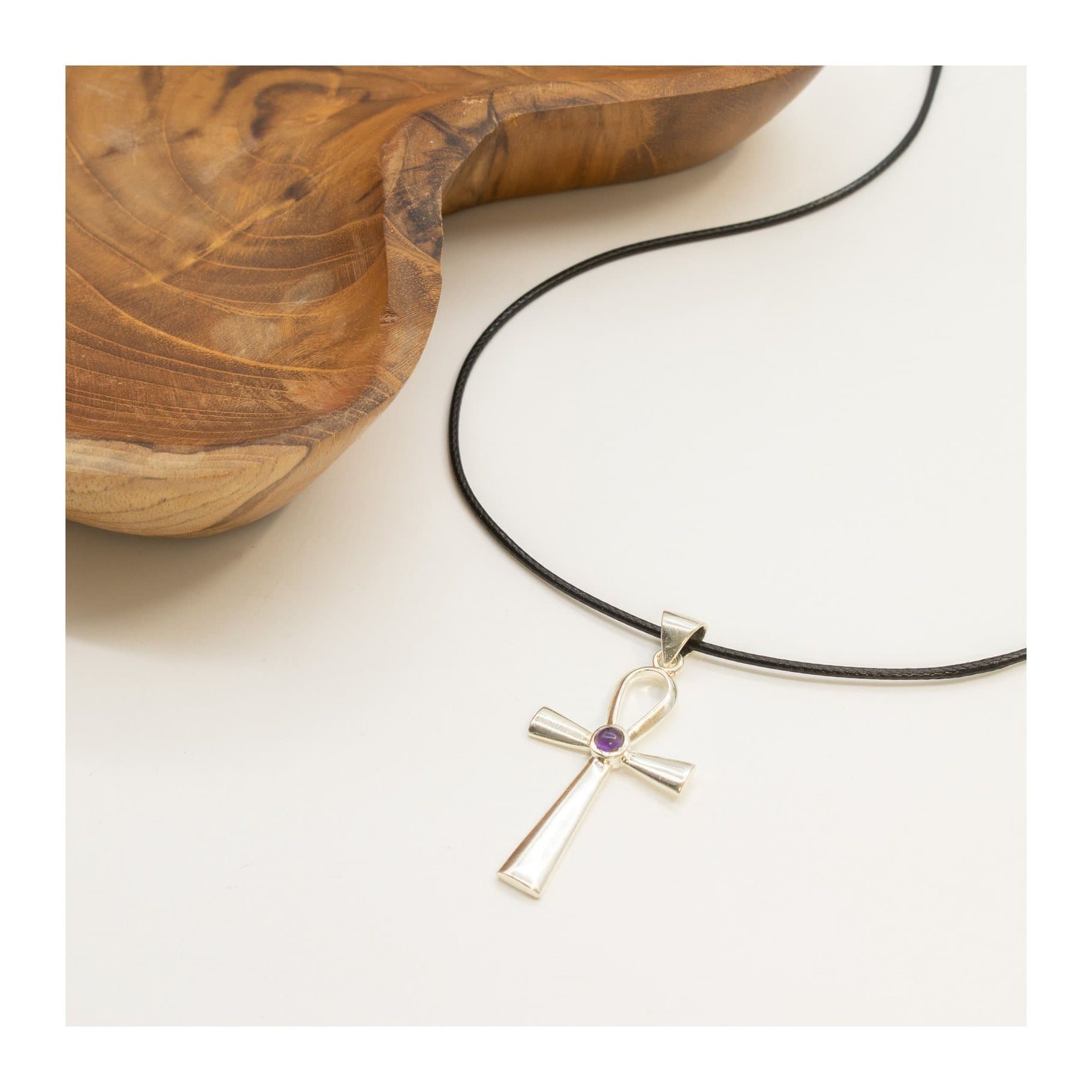Silver-plated ankh pendant with a small purple stone on a black cord