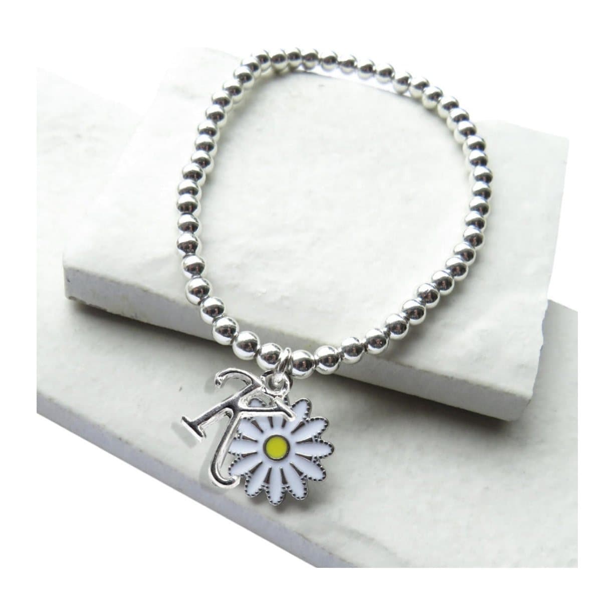Silver beaded bracelet with a white daisy charm and a silver initial