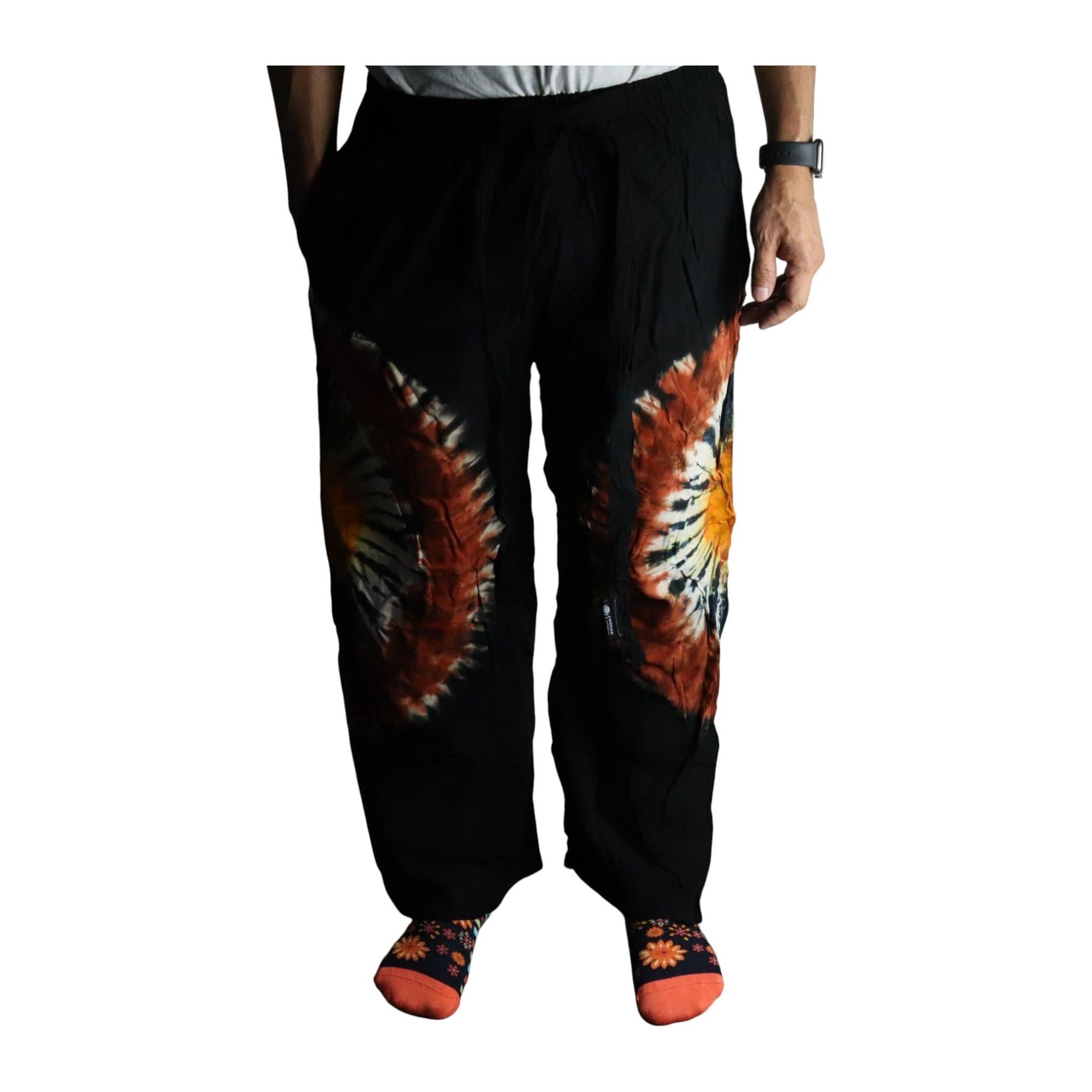 Lounge pants with an orange and chocolate tie-dye burst on a deep black base