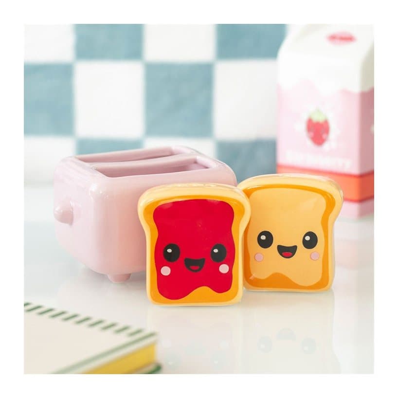 Two toast character shakers in a pink toaster holder