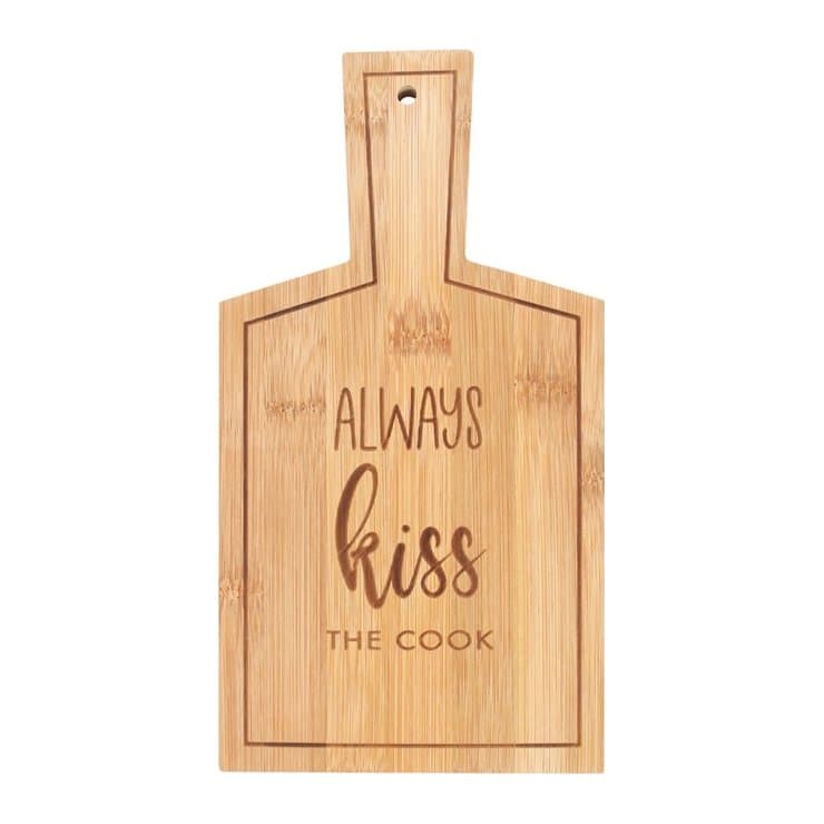 Bamboo serving board with the wording Always Kiss the Cook