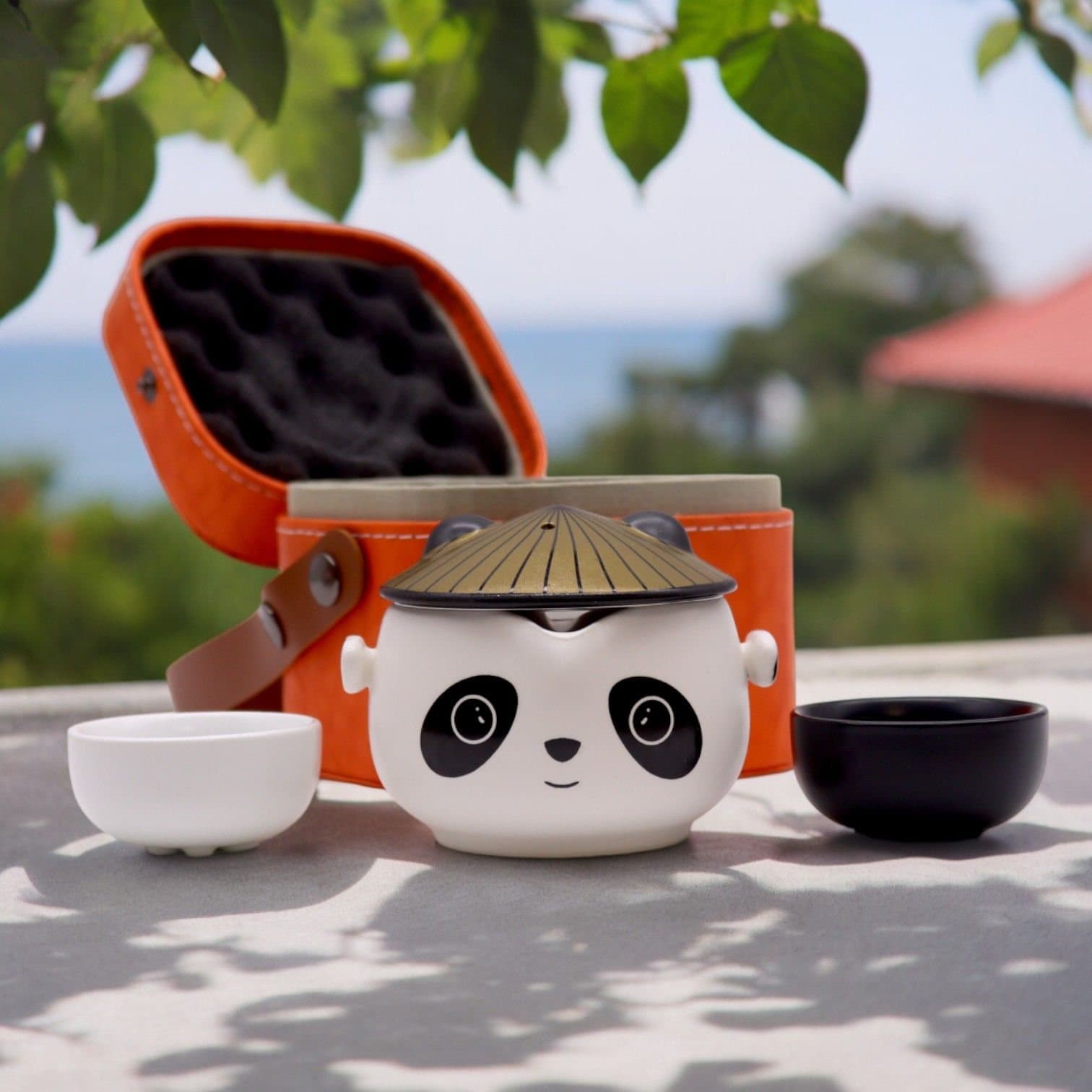 Panda face teapot with two cups and orange travel case