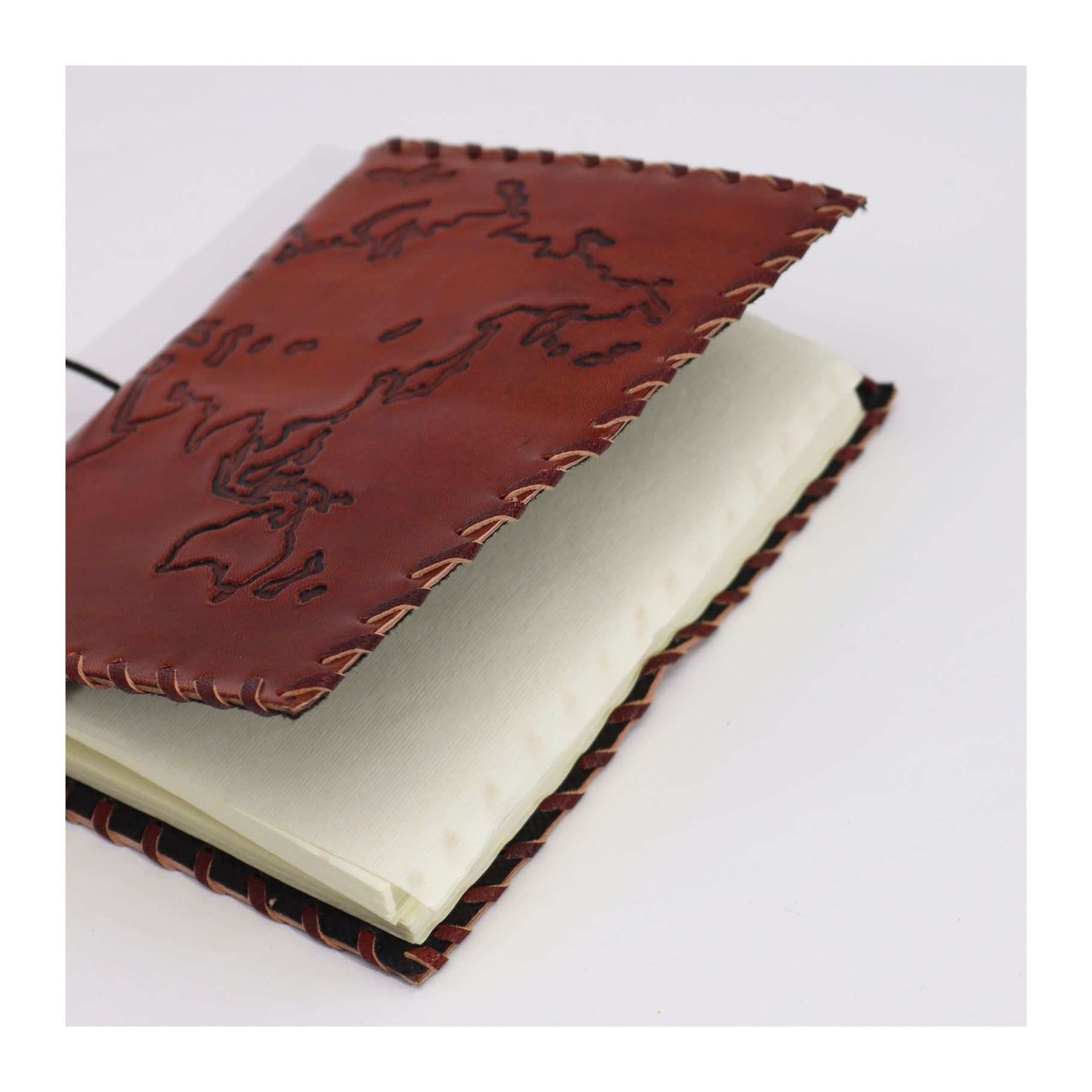 Tan leather travel journal with a wrap tie