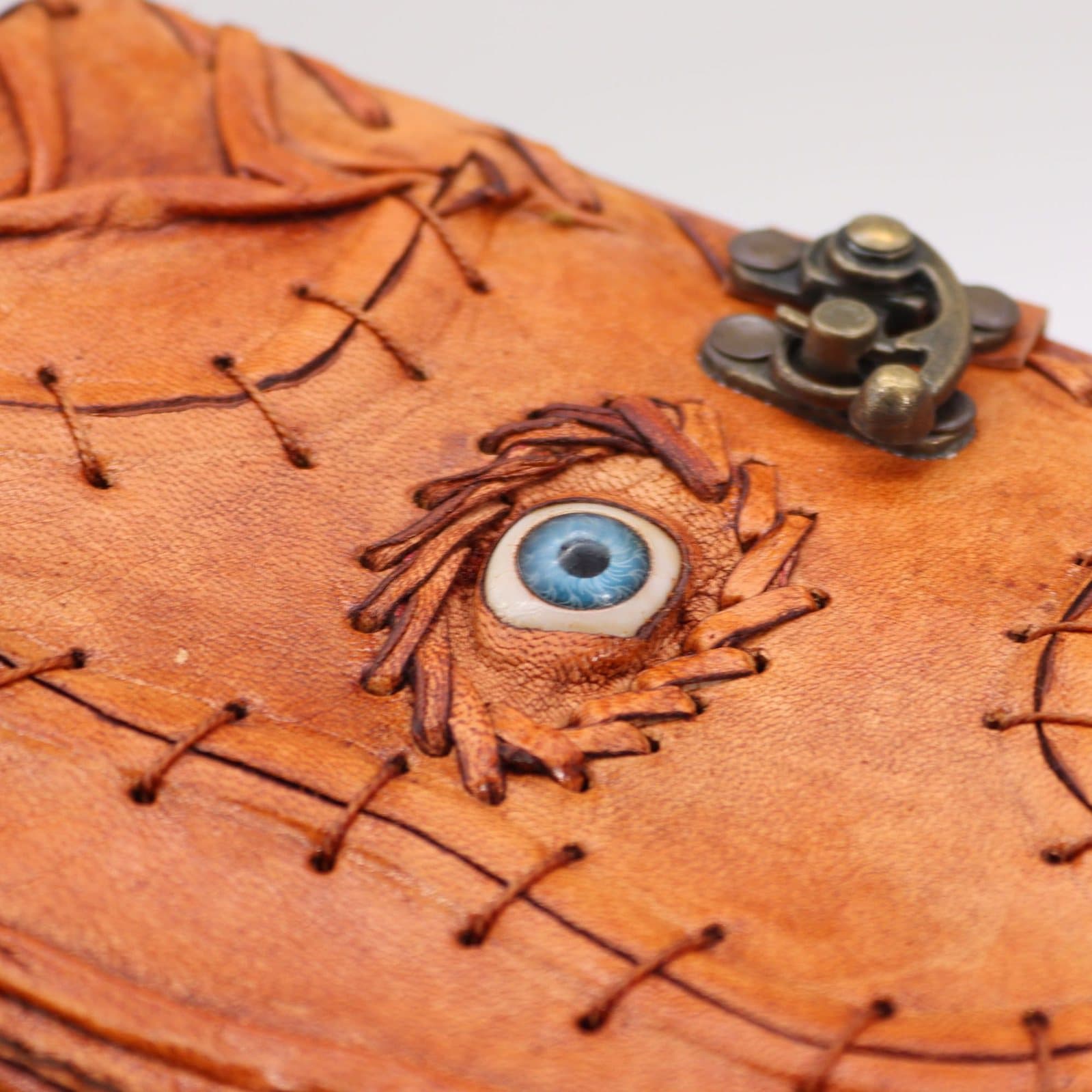 Light brown tan notebook with evil eye decor and deckle edge pages