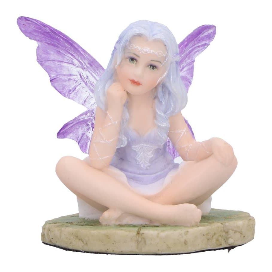 Lila, a lavender fairy figurine seated on a rocky path in a purple gown