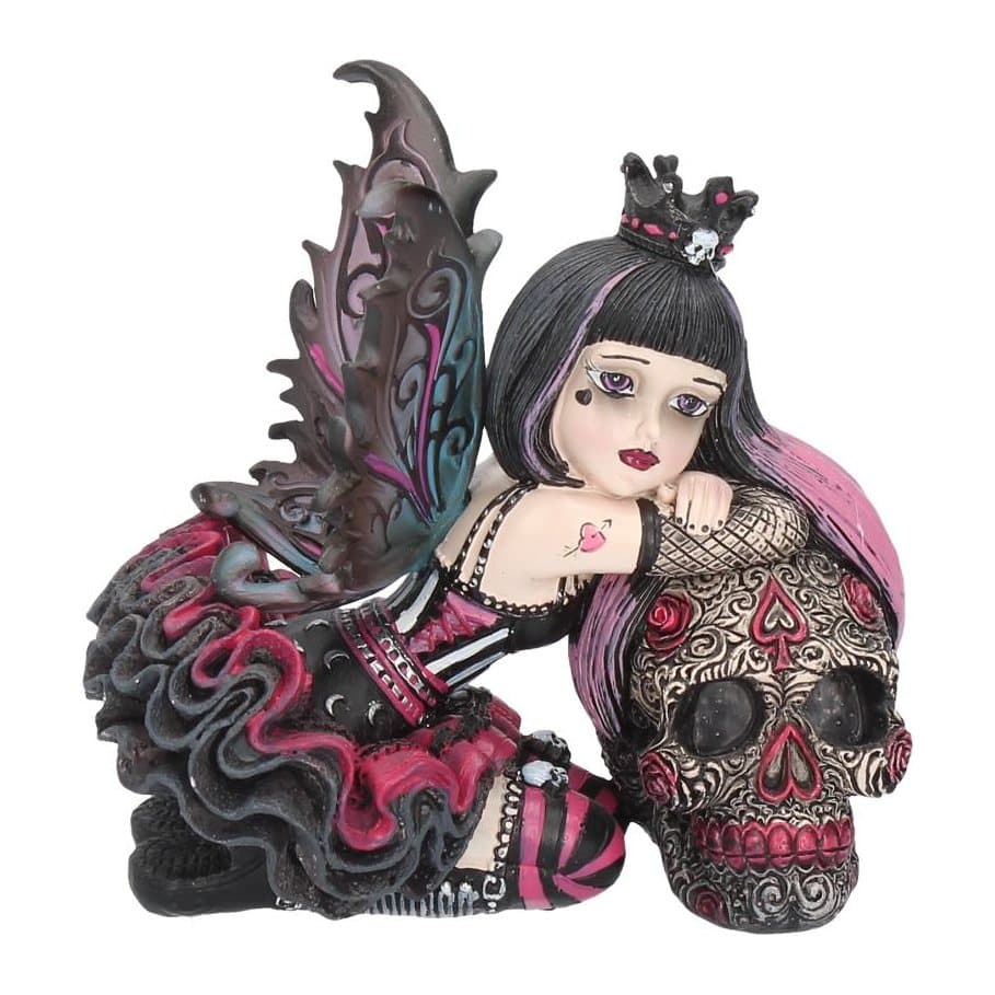Gothic fairy figurine with skull crown kneeling beside a large painted skull
