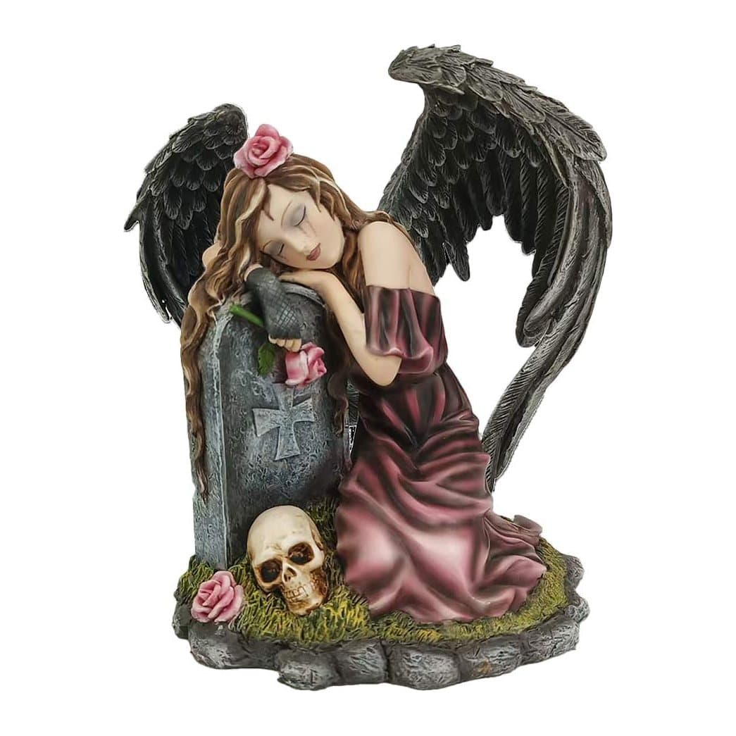 Resin mourning angel figurine beside a gravestone with black wings, a skull and roses