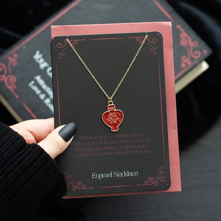 Enamel love potion necklace on a matching greeting card