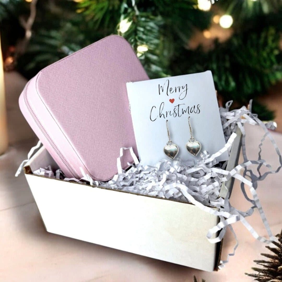 Silver heart drop earrings, a pink square jewellery box and a Merry Christmas card