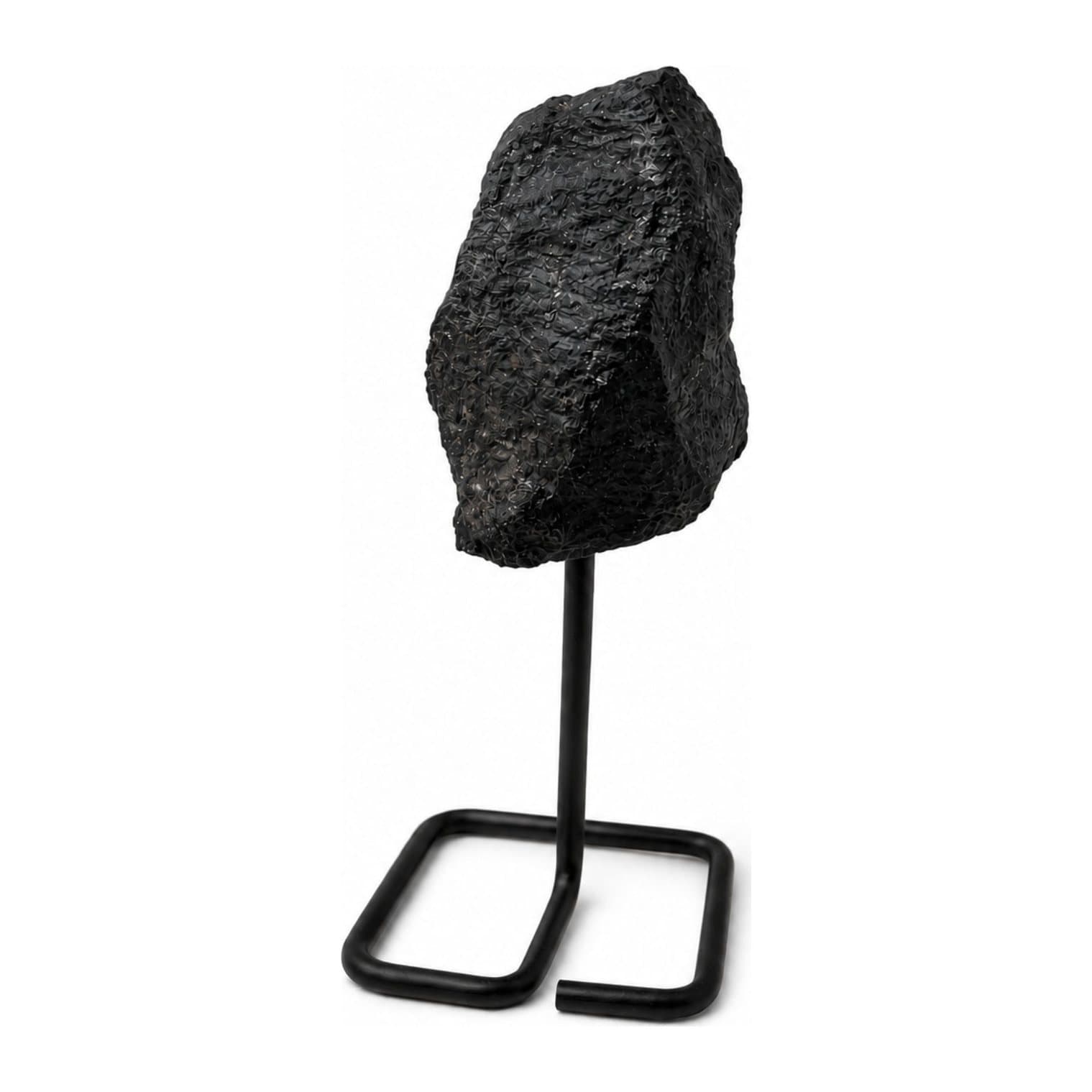 Black tourmaline mineral specimen on a black metal stand