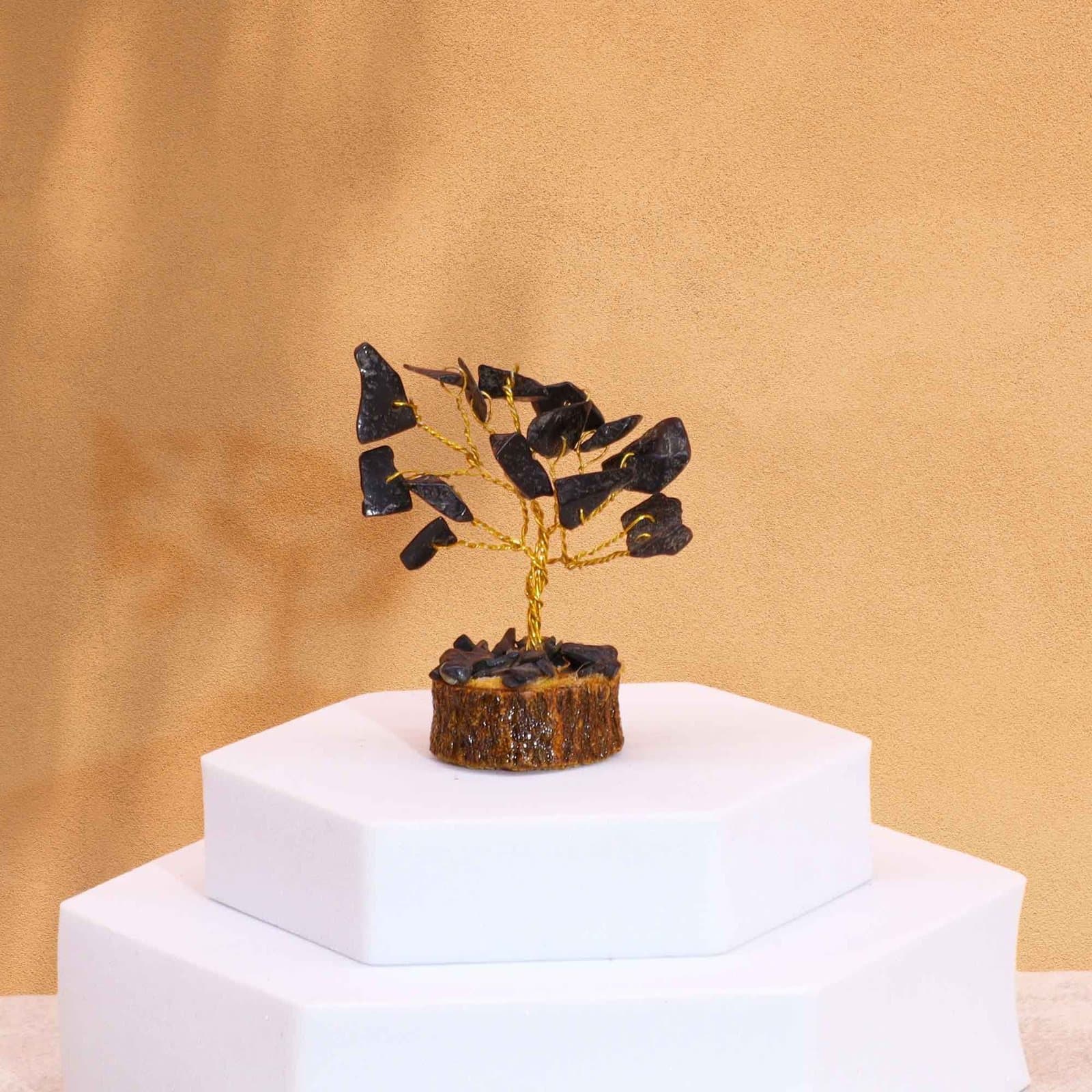Mini gemstone tree with black agate stones on a wood base