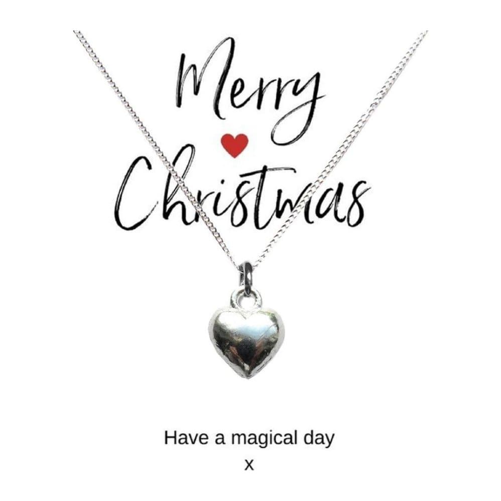 Silver heart charm necklace on a Merry Christmas card
