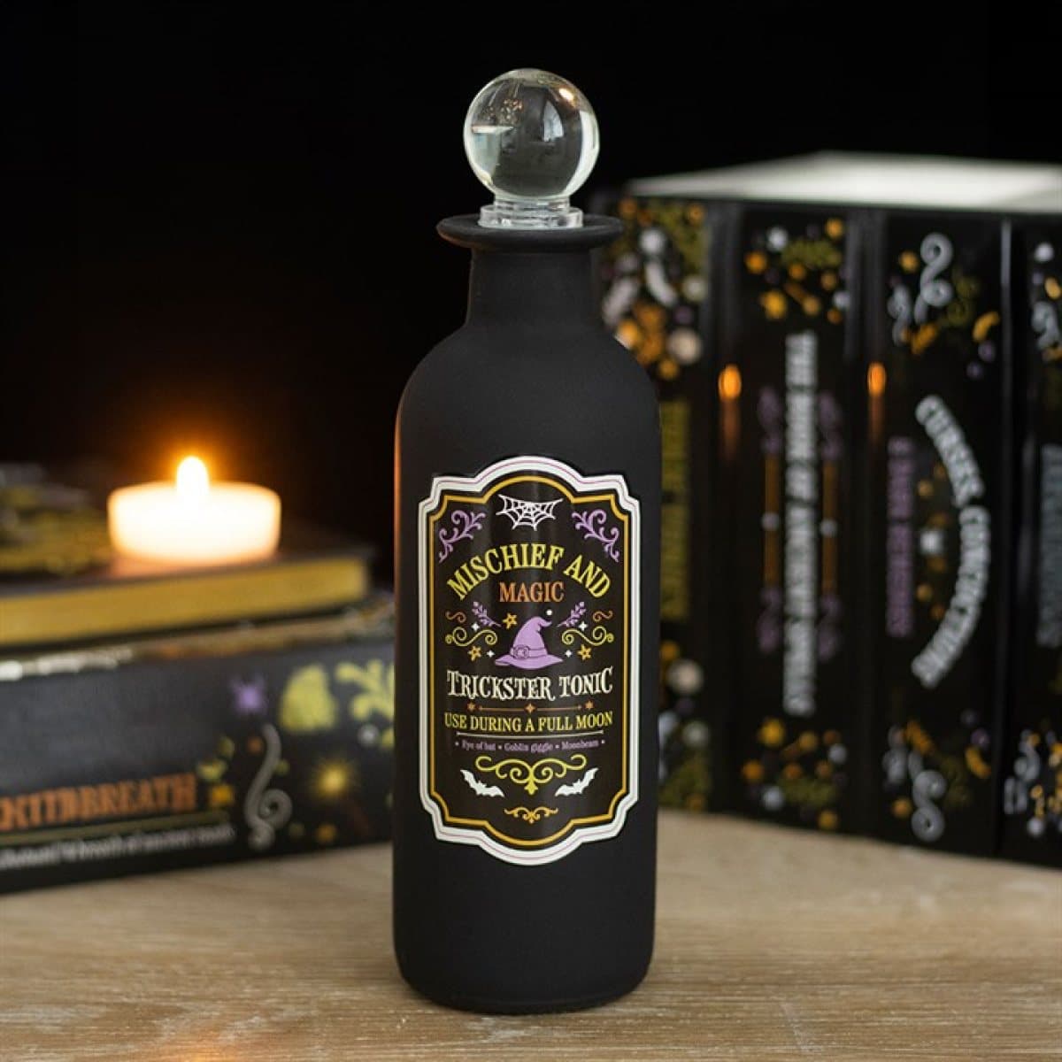 Glass potion bottle with Mischief and Magic label and clear stopper lid