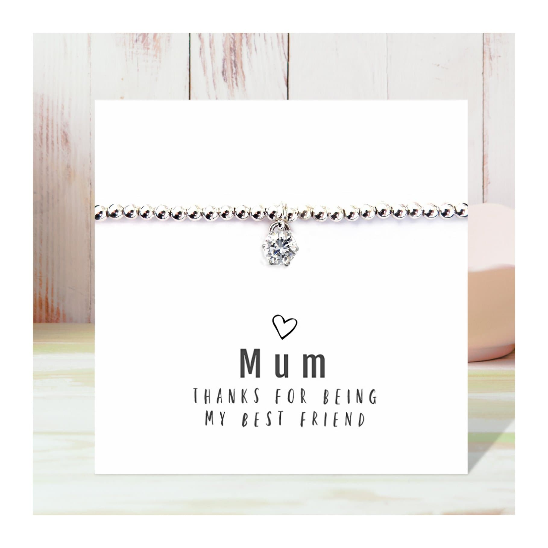 Stretch beaded bracelet with a cubic zirconia charm on a message card