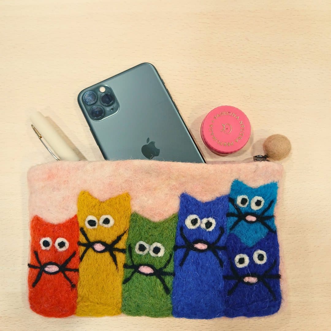 Three felt zipper pouches decorated with colourful appliqué cats