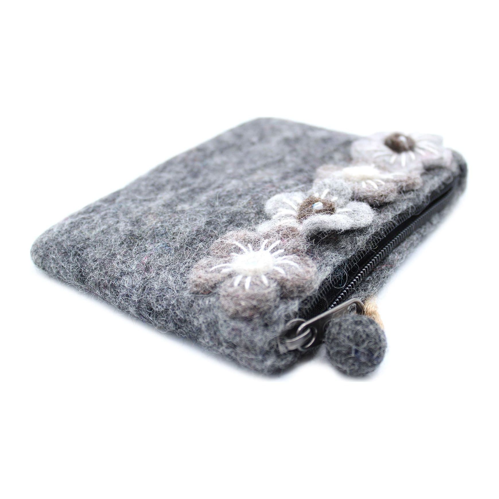 Three felt zipper pouches with layered felt flowers and felt-ball zip pulls