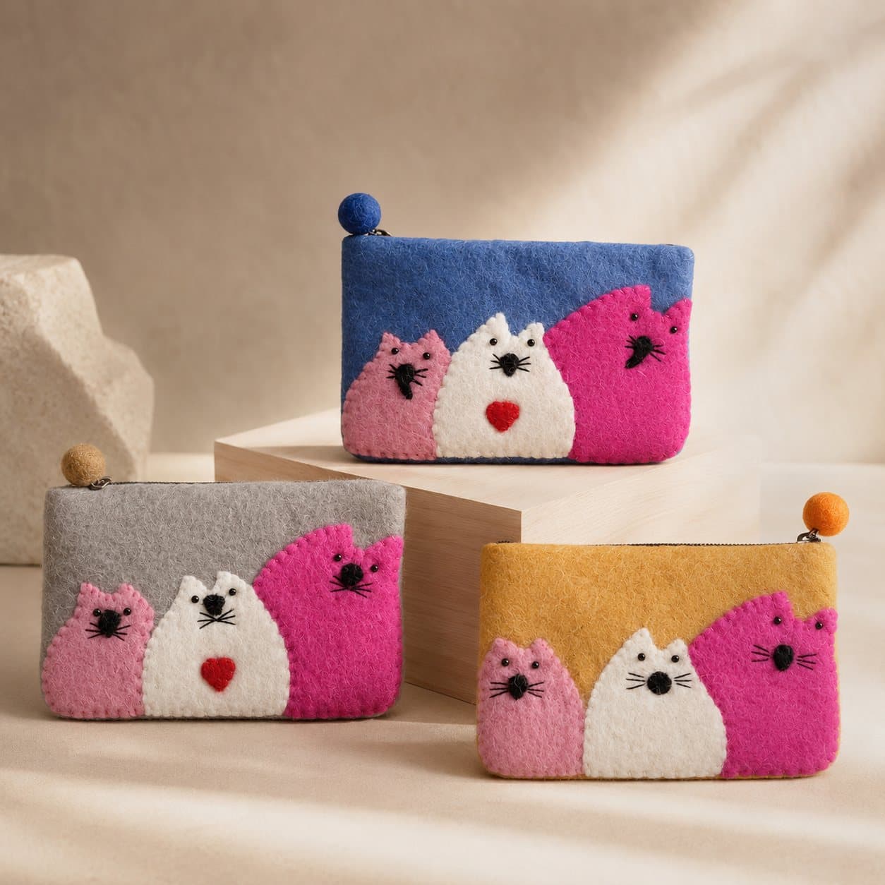 Three felt zipper pouches with pink, white and fuchsia appliqué cats