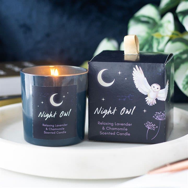Night Owl candle in a glass holder with a gold-tone metal lid