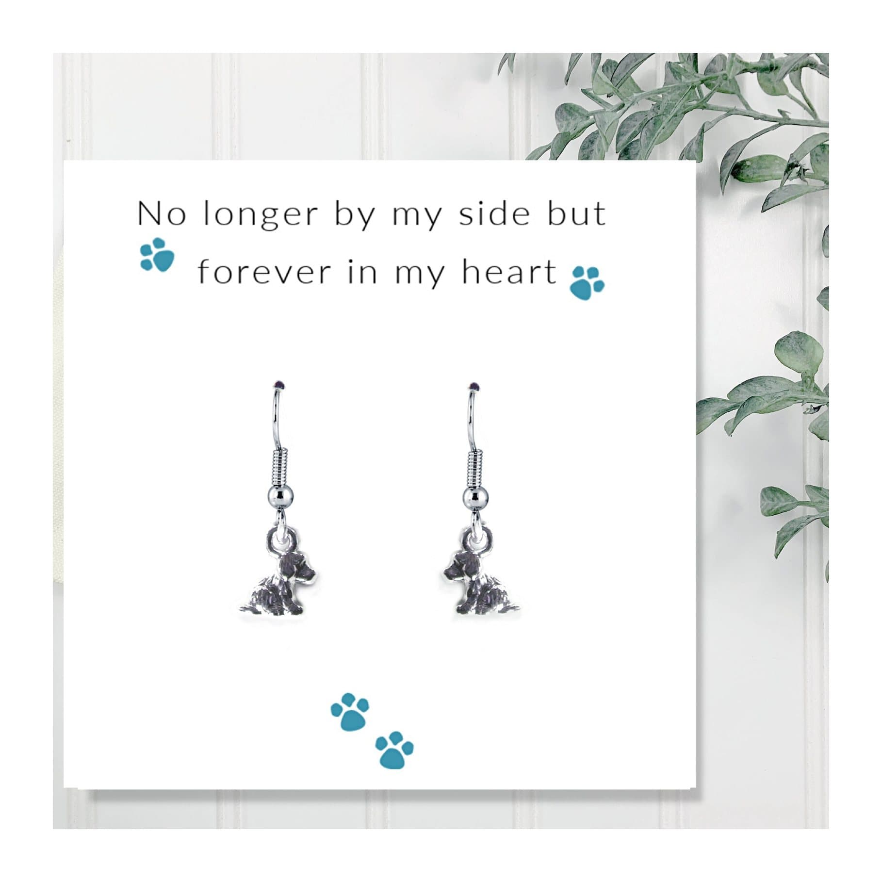 Puppy dog earrings on a message card reading No longer by my side