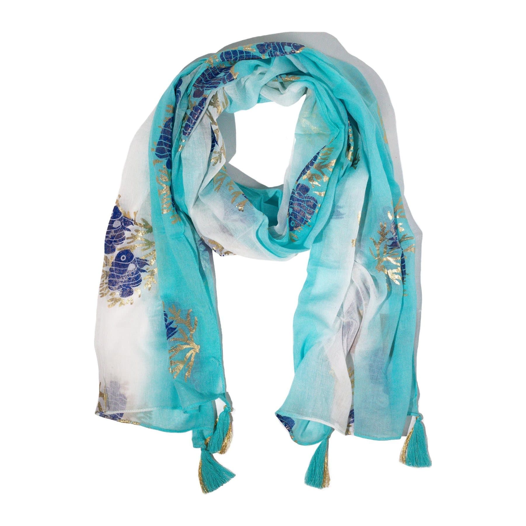 Turquoise scarf with blue fish motifs, gold foil details and tassels at the ends