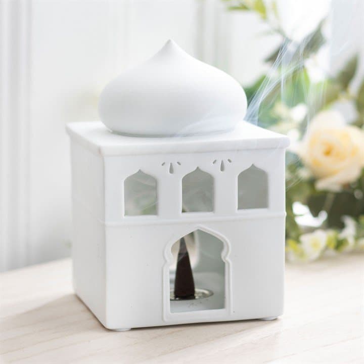 Glossy off-white ceramic mosque oil burner with lit windows and door