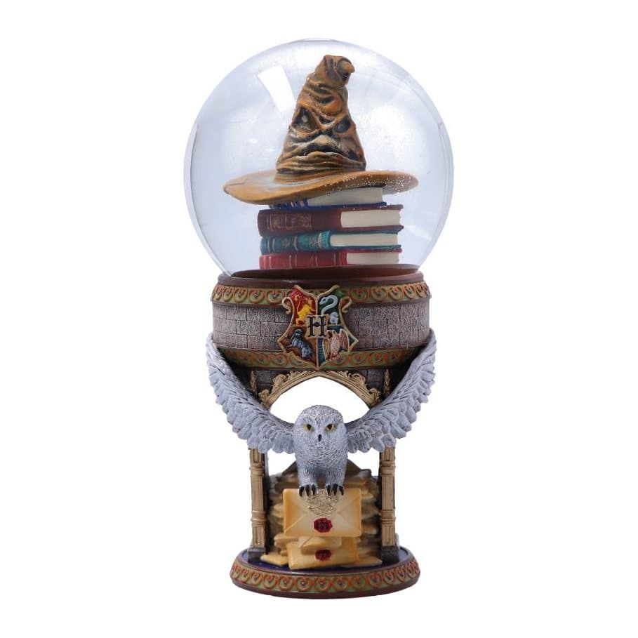 Hogwarts snow globe with Hedwig the owl and the Sorting Hat on spell books