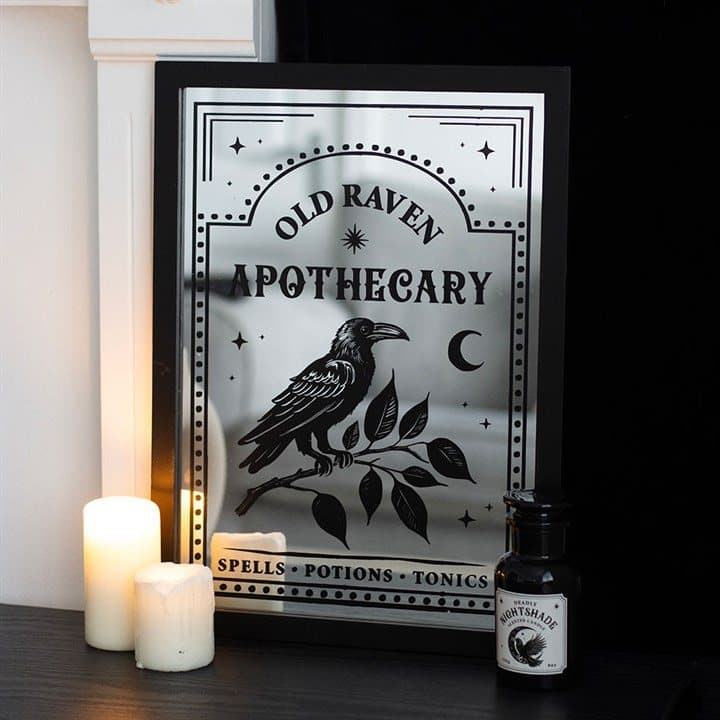 Mirrored glass wall art with vintage apothecary label, raven and botanical designs