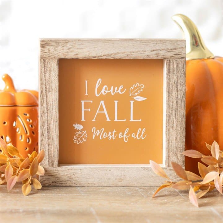 Square orange I Love Fall Most of All sign in an unfinished wooden frame