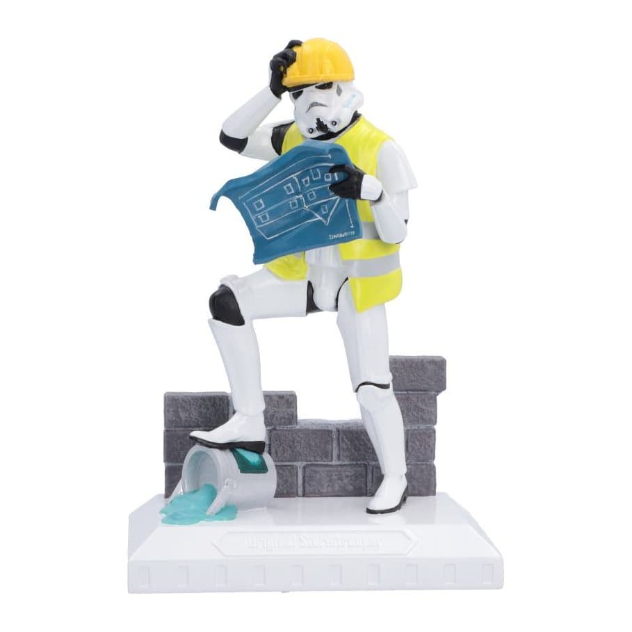 Stormtrooper figurine in hard hat beside a partially built brick wall