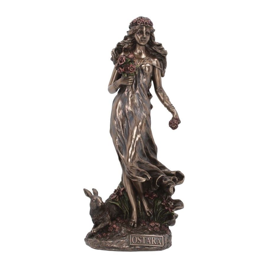 Ostara figurine in a long dress holding red roses, with a hare at her feet