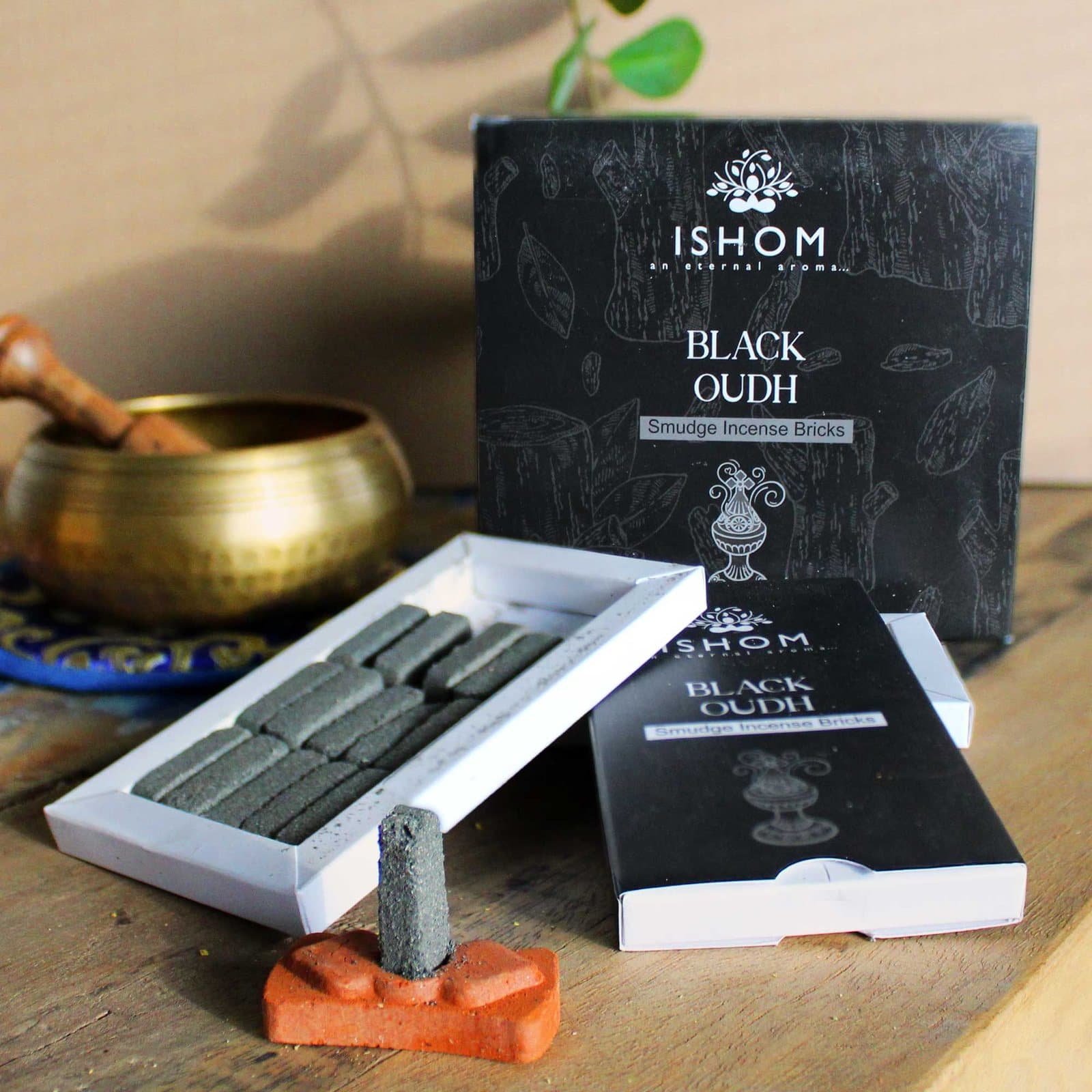 Pack of 15 black wood incense bricks with a terracotta holder