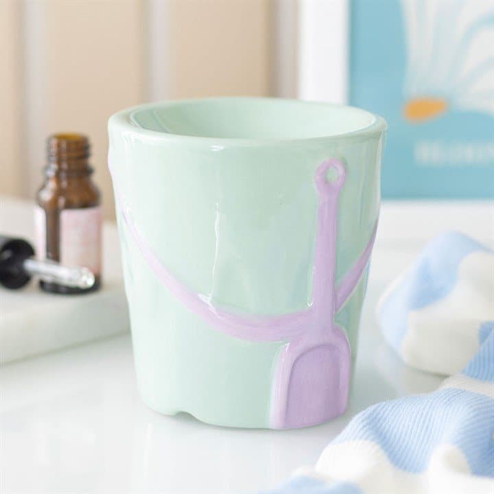 Pastel ceramic oil burner shaped like a bucket and spade