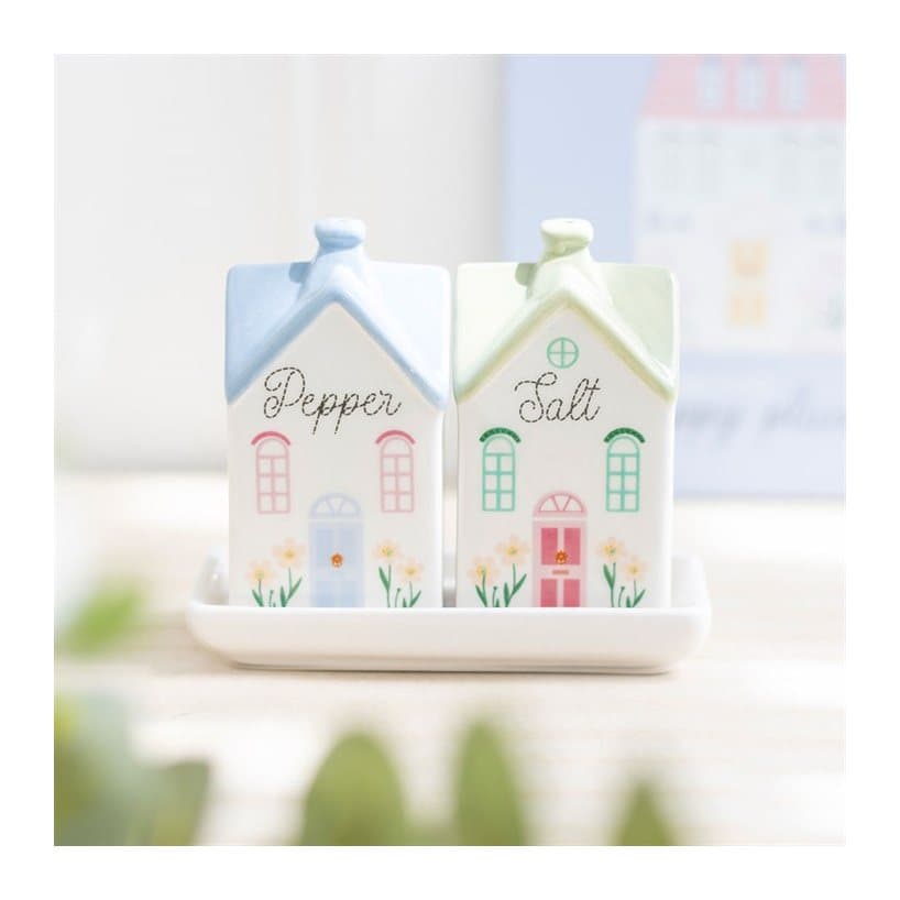 Two pastel ceramic house shaped salt and pepper shakers